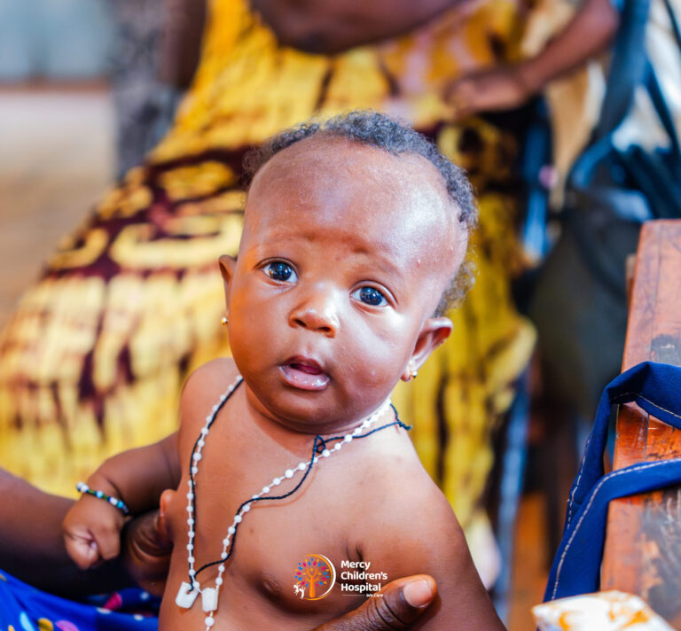 An infant looking at the camera