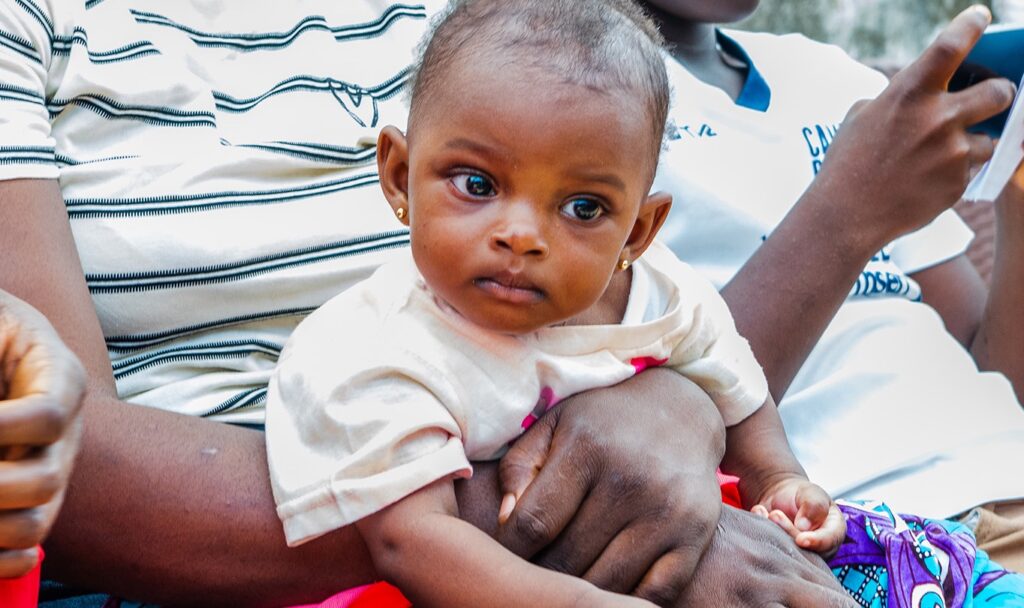 A baby looking up at the camera