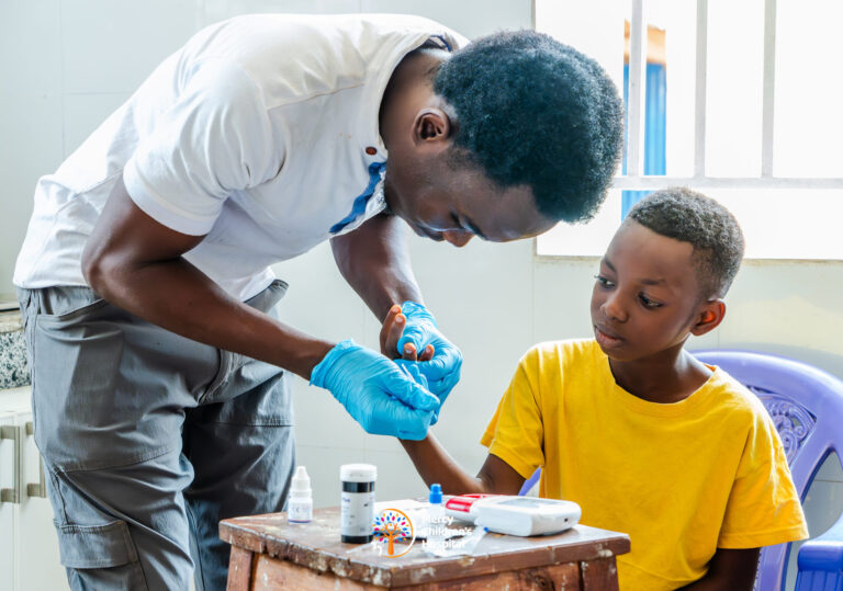 A health worker giving medicine to a child at a free medical mission