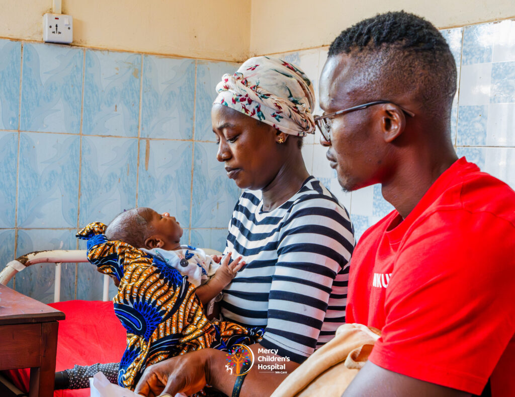 Parents sitting with their newborn baby at the hospital