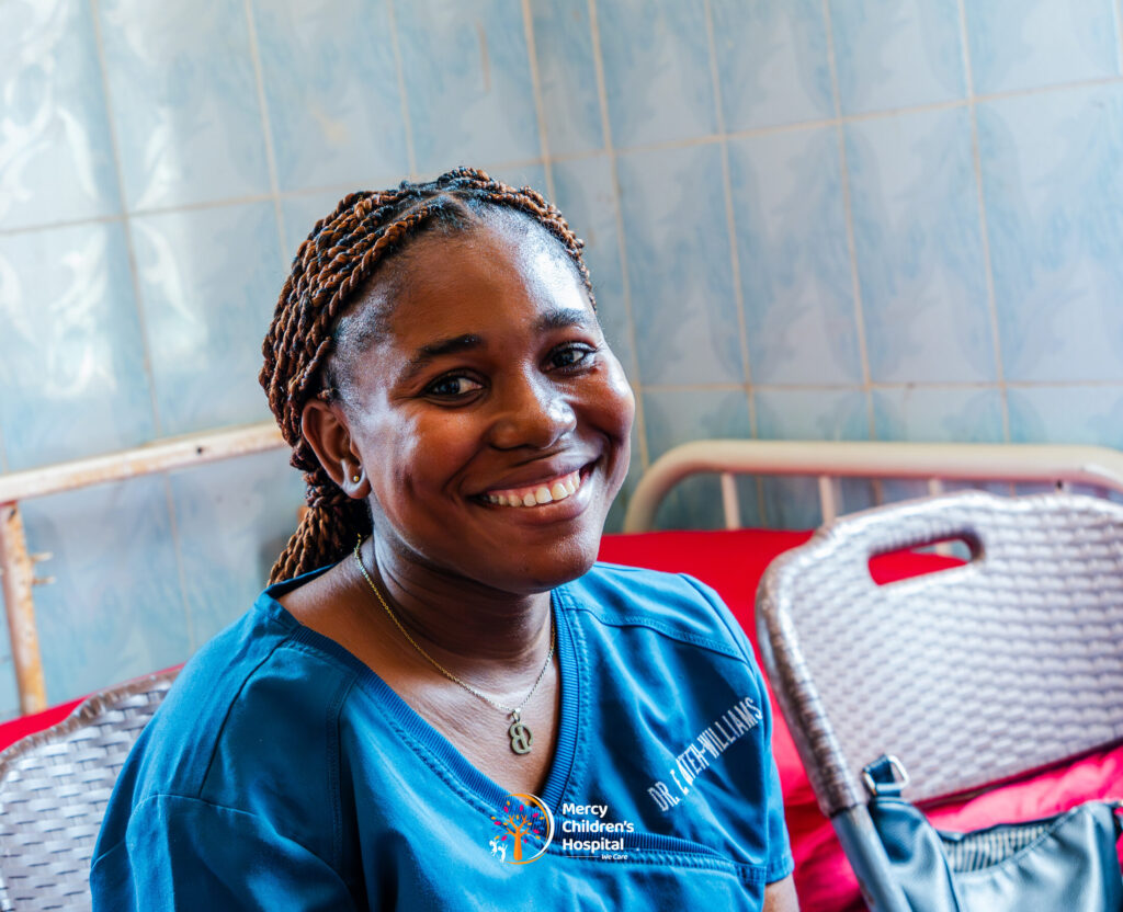 A member of the nursing team smiling on the ward