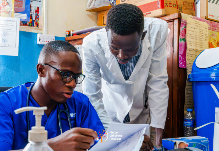 Two clinicians reviewing notes together